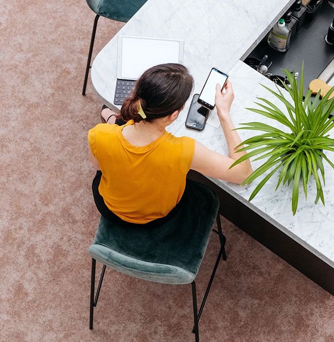 Woman Sitting at a Counter Working Woman Sitting at a Counter Working